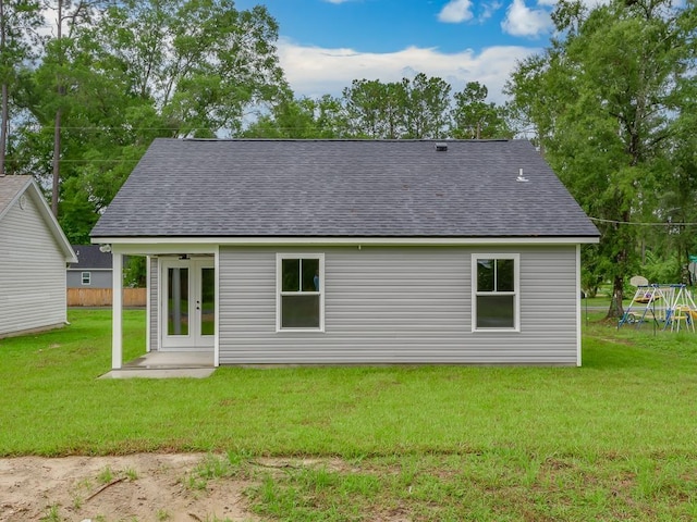 rear view of property featuring a yard and french doors