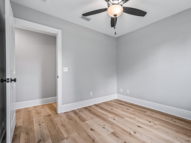 spare room with ceiling fan and light wood-type flooring