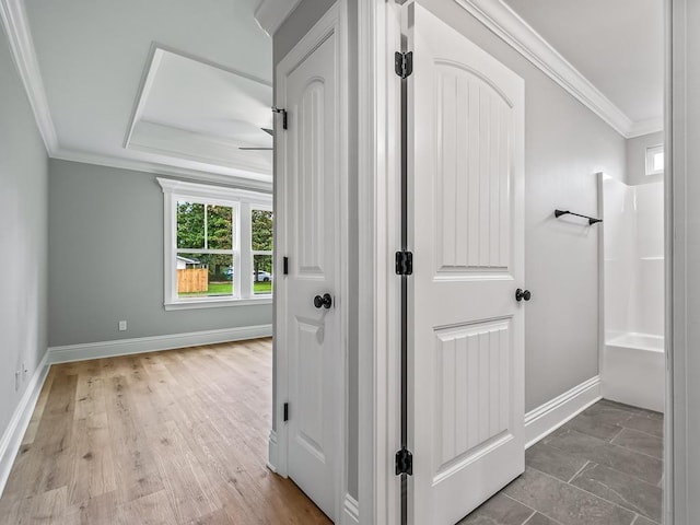 hallway with hardwood / wood-style flooring and ornamental molding