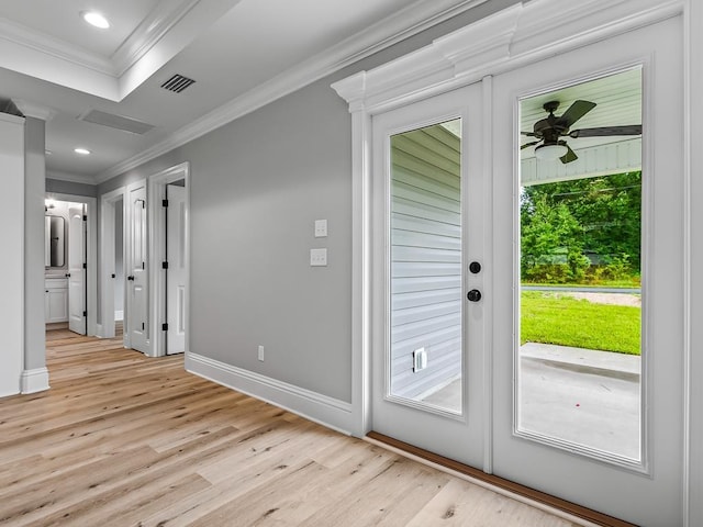 doorway featuring ornamental molding, ceiling fan, and light hardwood / wood-style floors