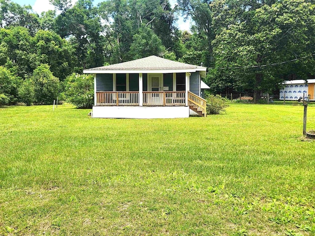 view of front of house with a front yard and a porch