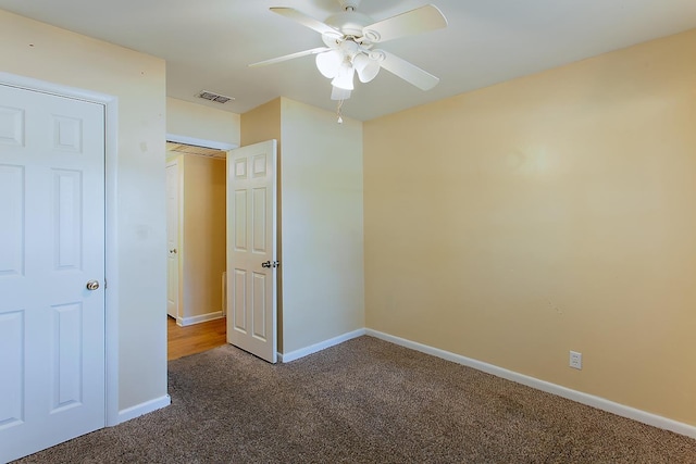 1318 W Tharpe St, Tallahassee, FL 32303 - unfurnished bedroom with dark colored carpet, baseboards, and ceiling fan