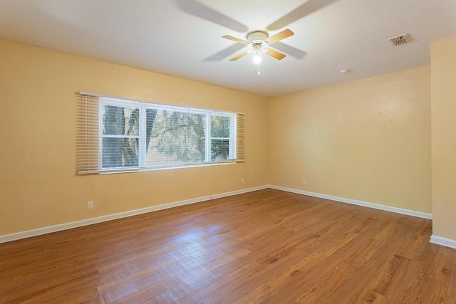 1318 W Tharpe St, Tallahassee, FL 32303 - unfurnished room with a ceiling fan, wood finished floors, and baseboards
