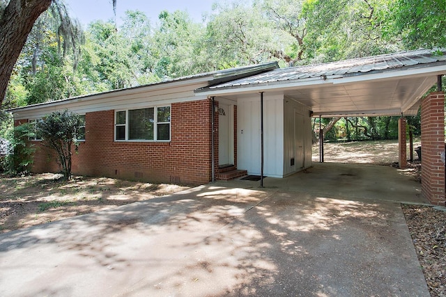 1318 W Tharpe St, Tallahassee, FL 32303 - view of front of property featuring entry steps, driveway, crawl space, board and batten siding, and metal roof