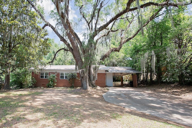 1318 W Tharpe St, Tallahassee, FL 32303 - view of front of home featuring driveway, a carport, crawl space, brick siding, and metal roof