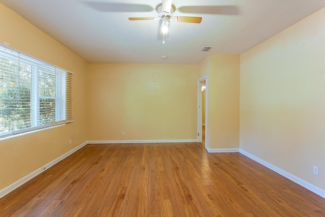 1318 W Tharpe St, Tallahassee, FL 32303 - empty room with wood finished floors, ceiling fan, and baseboards