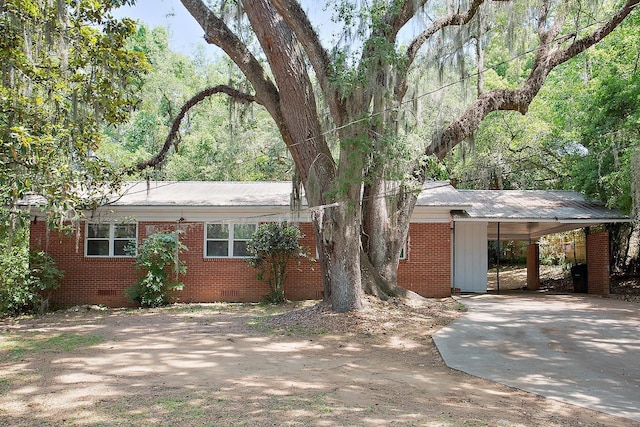 1318 W Tharpe St, Tallahassee, FL 32303 - view of front facade featuring driveway, crawl space, metal roof, an attached carport, and brick siding