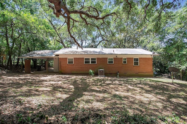 1318 W Tharpe St, Tallahassee, FL 32303 - back of property with crawl space, central AC unit, an attached carport, and brick siding