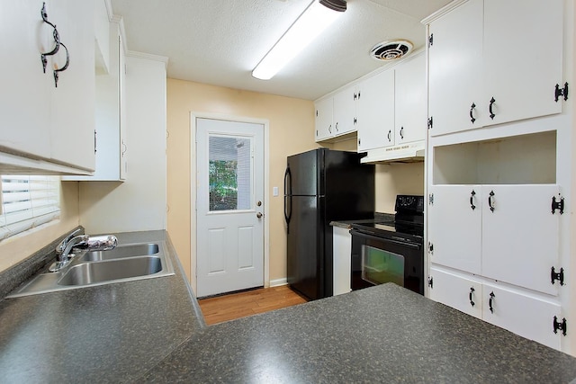 1318 W Tharpe St, Tallahassee, FL 32303 - kitchen with black appliances, a sink, dark countertops, and white cabinets