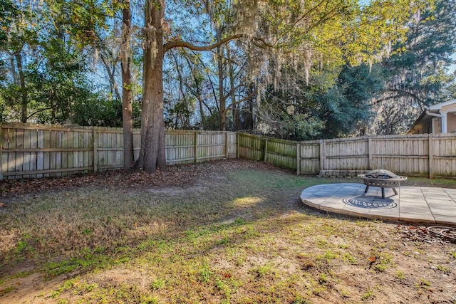 view of yard featuring a fire pit and a patio area