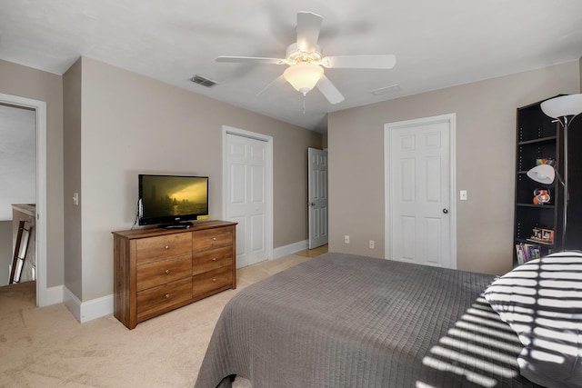 bedroom with ceiling fan and light carpet