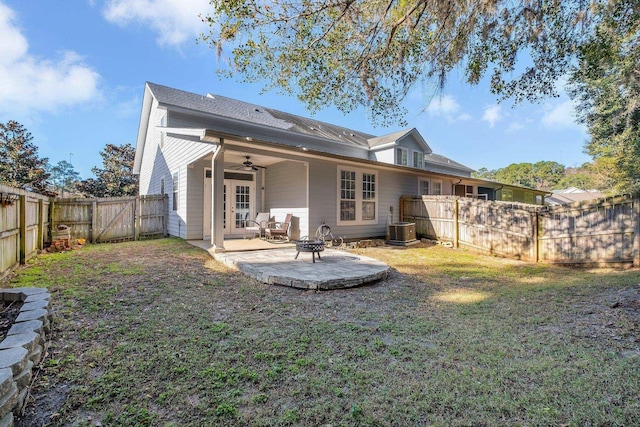 back of property with a lawn, ceiling fan, cooling unit, and a patio