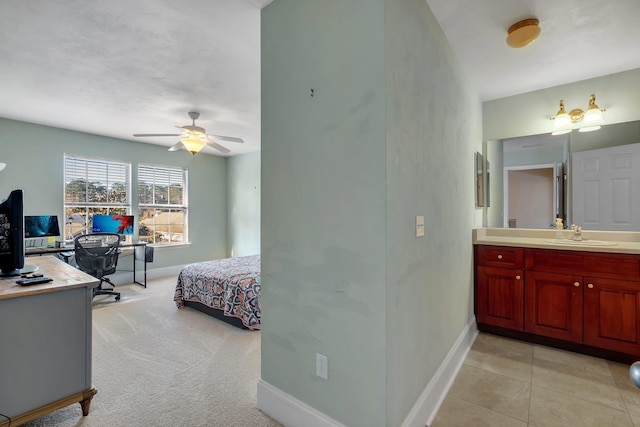 bedroom featuring light colored carpet, ceiling fan, and sink