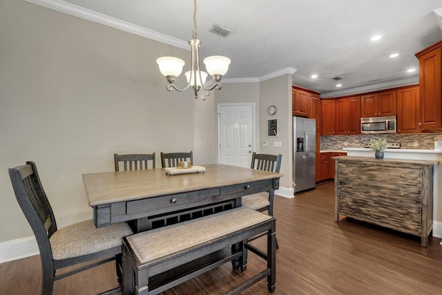 dining area with a notable chandelier, ornamental molding, and dark wood-type flooring