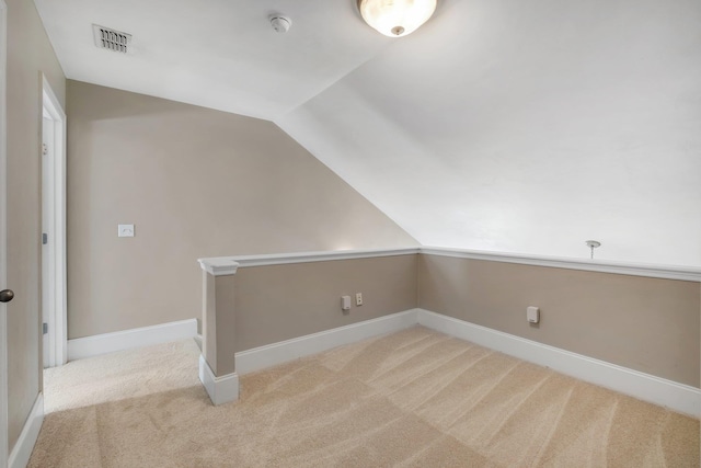 bonus room featuring light carpet and lofted ceiling