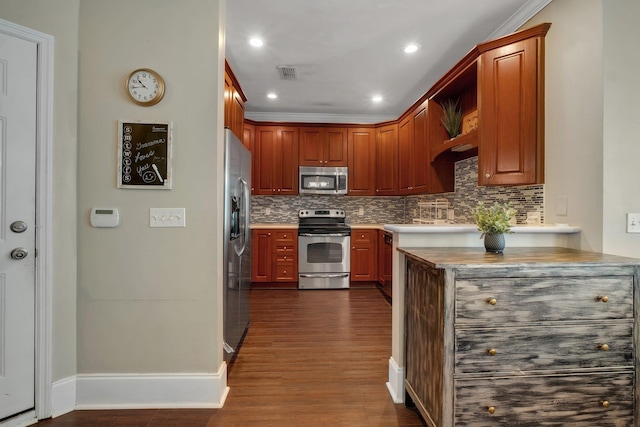 kitchen featuring dark hardwood / wood-style flooring, backsplash, stainless steel appliances, and crown molding