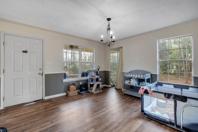 interior space featuring a notable chandelier, crown molding, and dark hardwood / wood-style floors