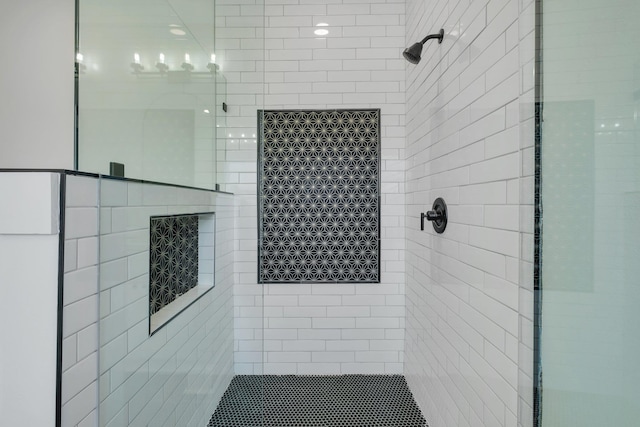 bathroom with a tile shower