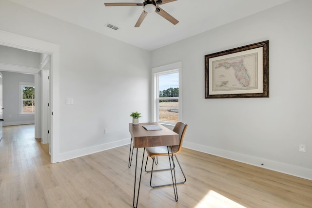 dining space with ceiling fan and light hardwood / wood-style floors