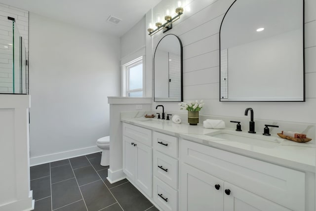 bathroom featuring tile patterned floors, vanity, and toilet