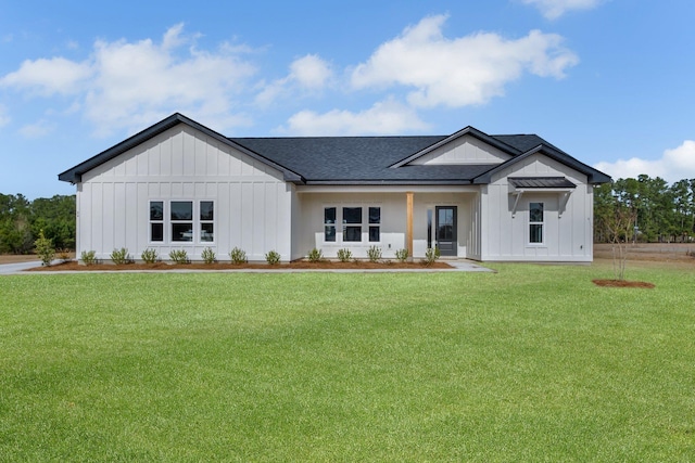 modern farmhouse featuring covered porch and a front lawn