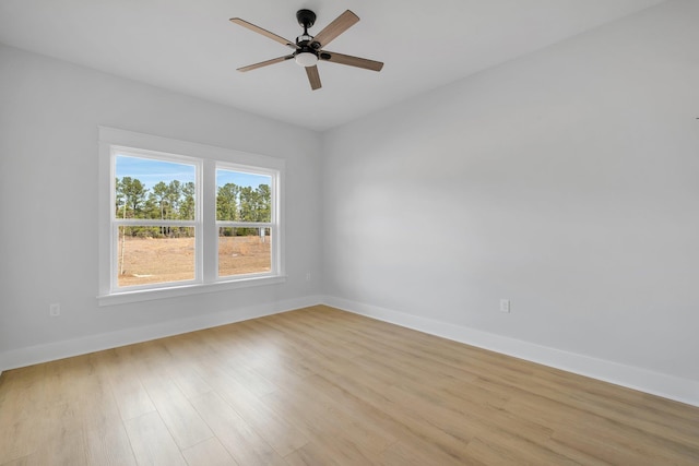 spare room with light hardwood / wood-style flooring and ceiling fan