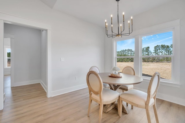 dining area with a chandelier and light hardwood / wood-style floors