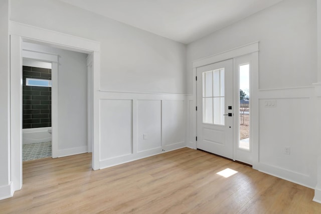 foyer with light hardwood / wood-style flooring and a healthy amount of sunlight