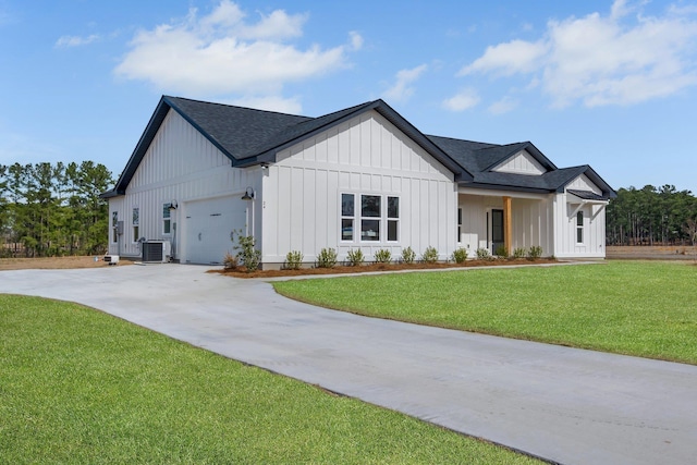 modern farmhouse style home with a garage, a front yard, and central air condition unit