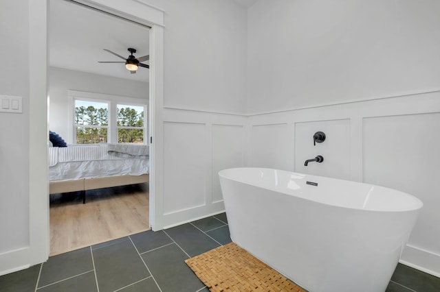 bathroom featuring ceiling fan, tile patterned floors, and a bathtub