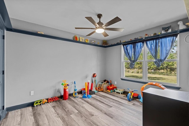 rec room featuring light hardwood / wood-style flooring and ceiling fan