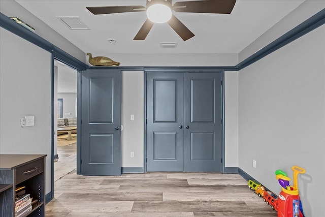 interior space with ceiling fan, a closet, and light wood-type flooring