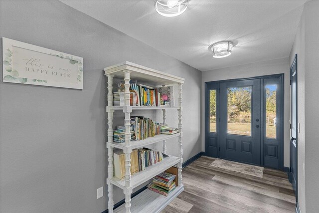 foyer featuring hardwood / wood-style flooring and a textured ceiling