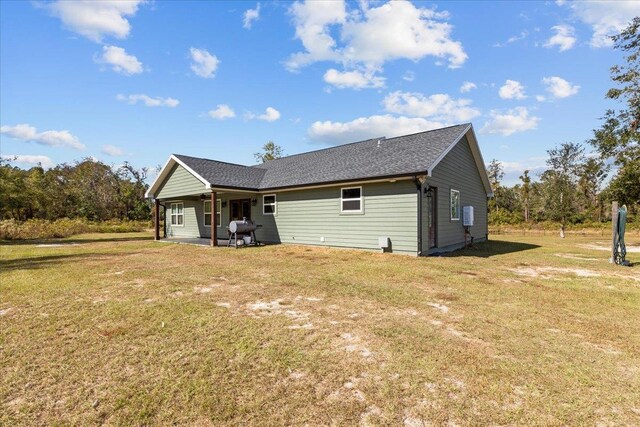 rear view of house with a yard