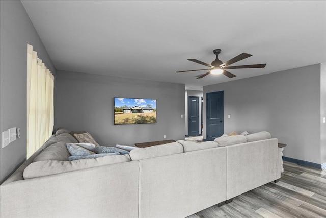 living room with hardwood / wood-style flooring and ceiling fan