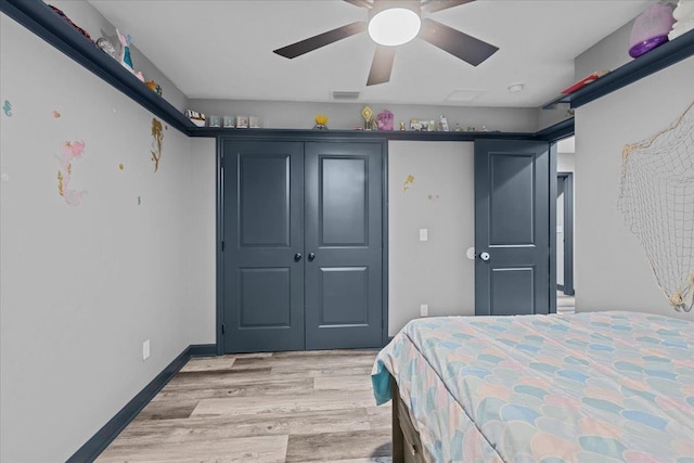 bedroom with ceiling fan, a closet, and light hardwood / wood-style flooring