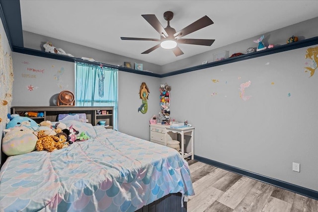 bedroom with light hardwood / wood-style flooring and ceiling fan