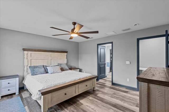 bedroom with ceiling fan and light hardwood / wood-style flooring