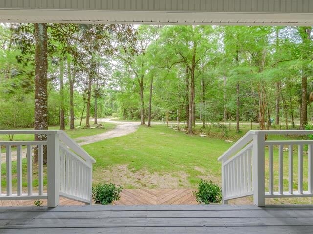 wooden terrace with a yard