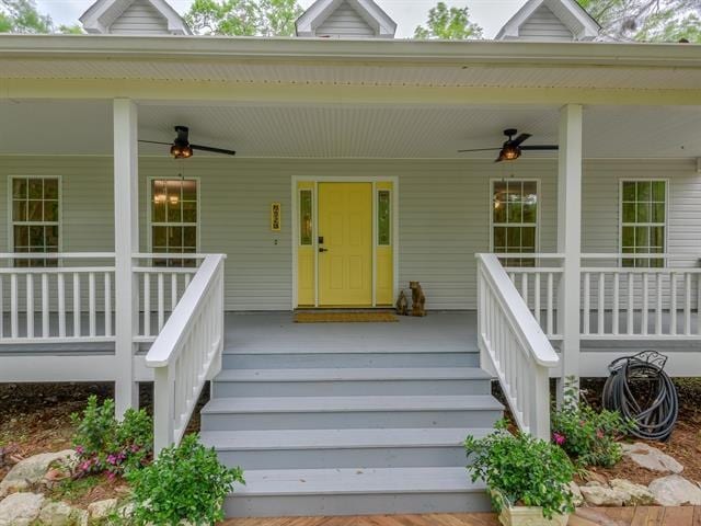 doorway to property with a porch and ceiling fan