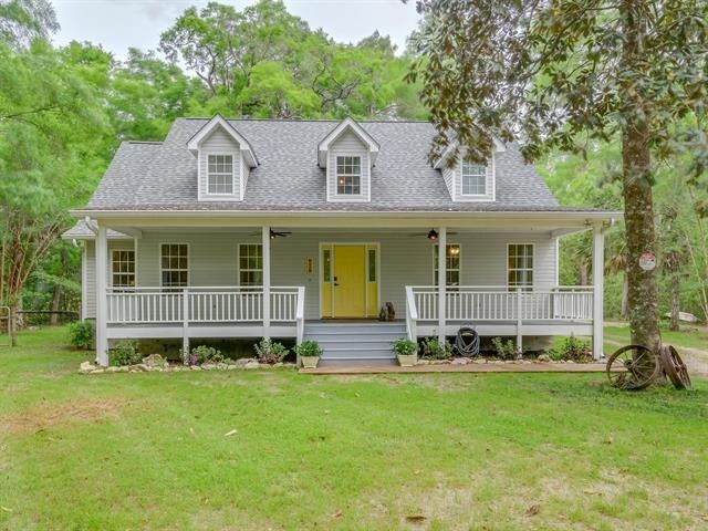 view of front of property with covered porch and a front yard