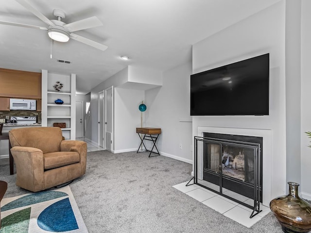 carpeted living room with ceiling fan