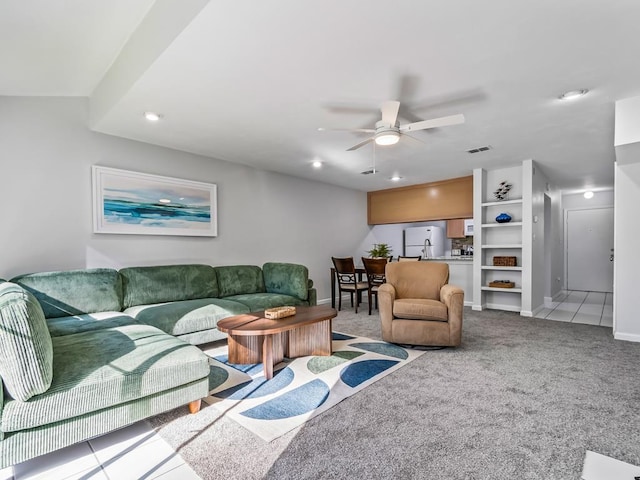 living room featuring light colored carpet and ceiling fan