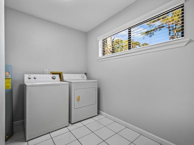 laundry area with separate washer and dryer and light tile patterned floors