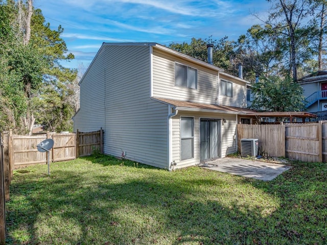 back of house with a yard, central AC unit, and a patio area