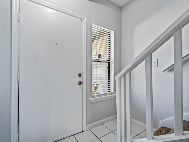 foyer entrance with light tile patterned floors