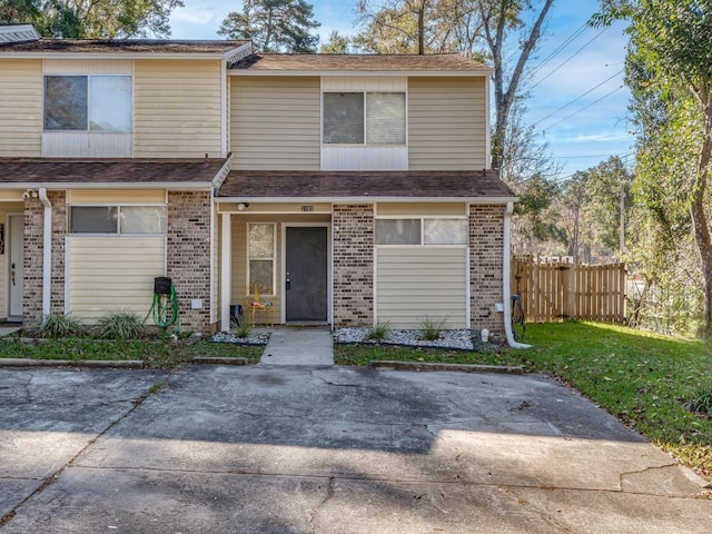 multi unit property featuring a patio and a front yard