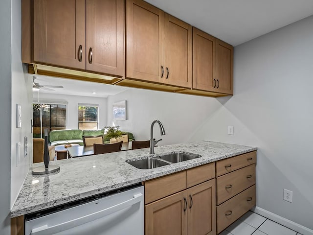 kitchen with light tile patterned flooring, dishwasher, sink, light stone counters, and kitchen peninsula