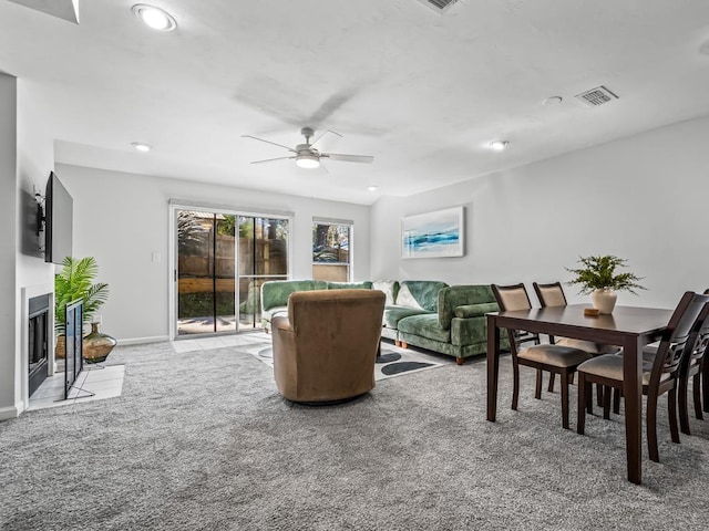 carpeted living room featuring ceiling fan