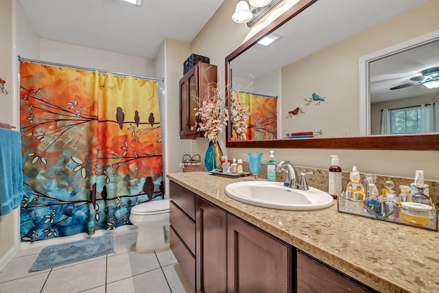 bathroom featuring tile patterned floors, ceiling fan, vanity, and toilet